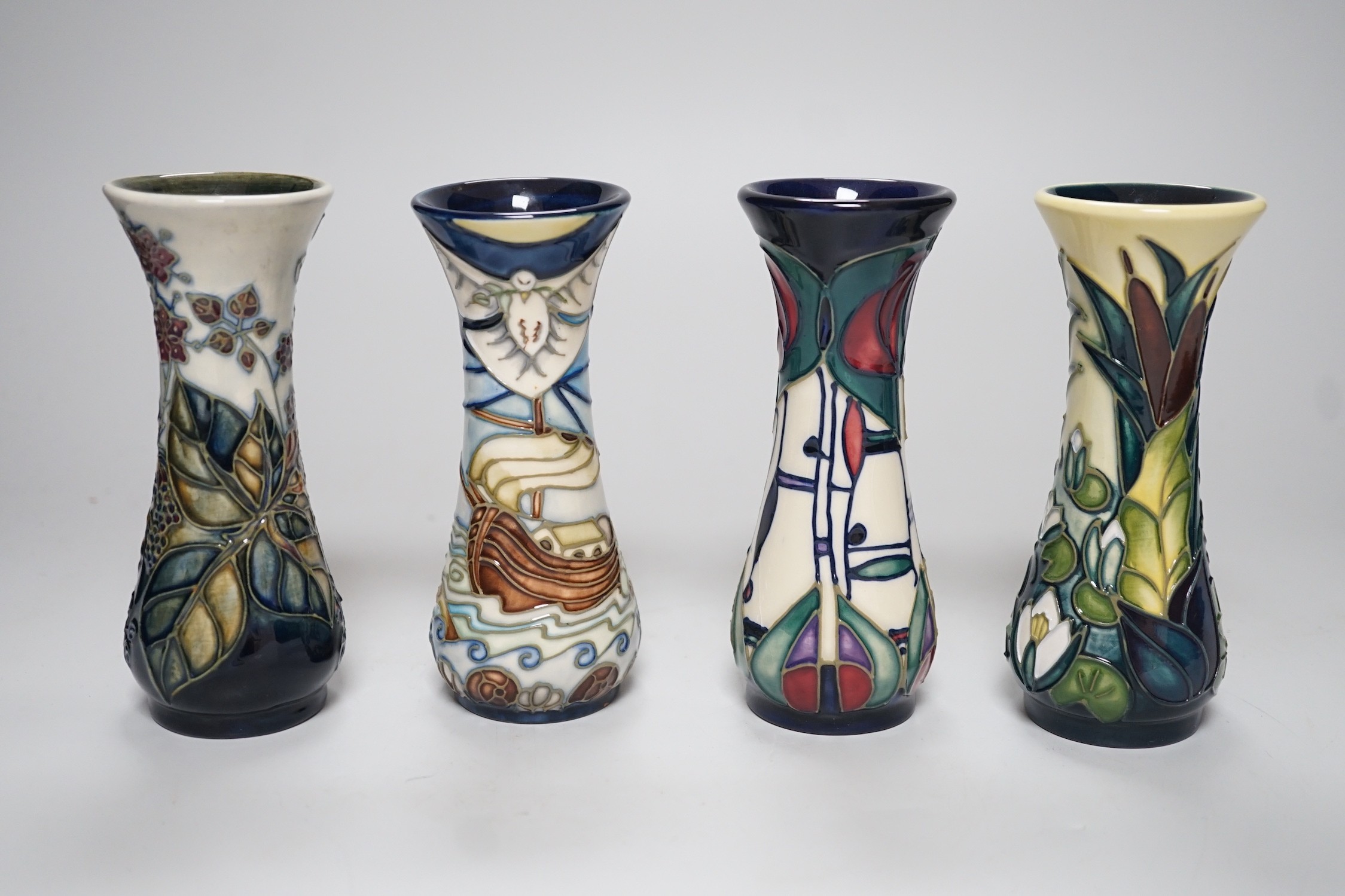 Four boxed small Moorcroft vases, Blackberry, Bulrush, Winds of Change, and a Rennie Macintosh Tribute. Each 11cm high